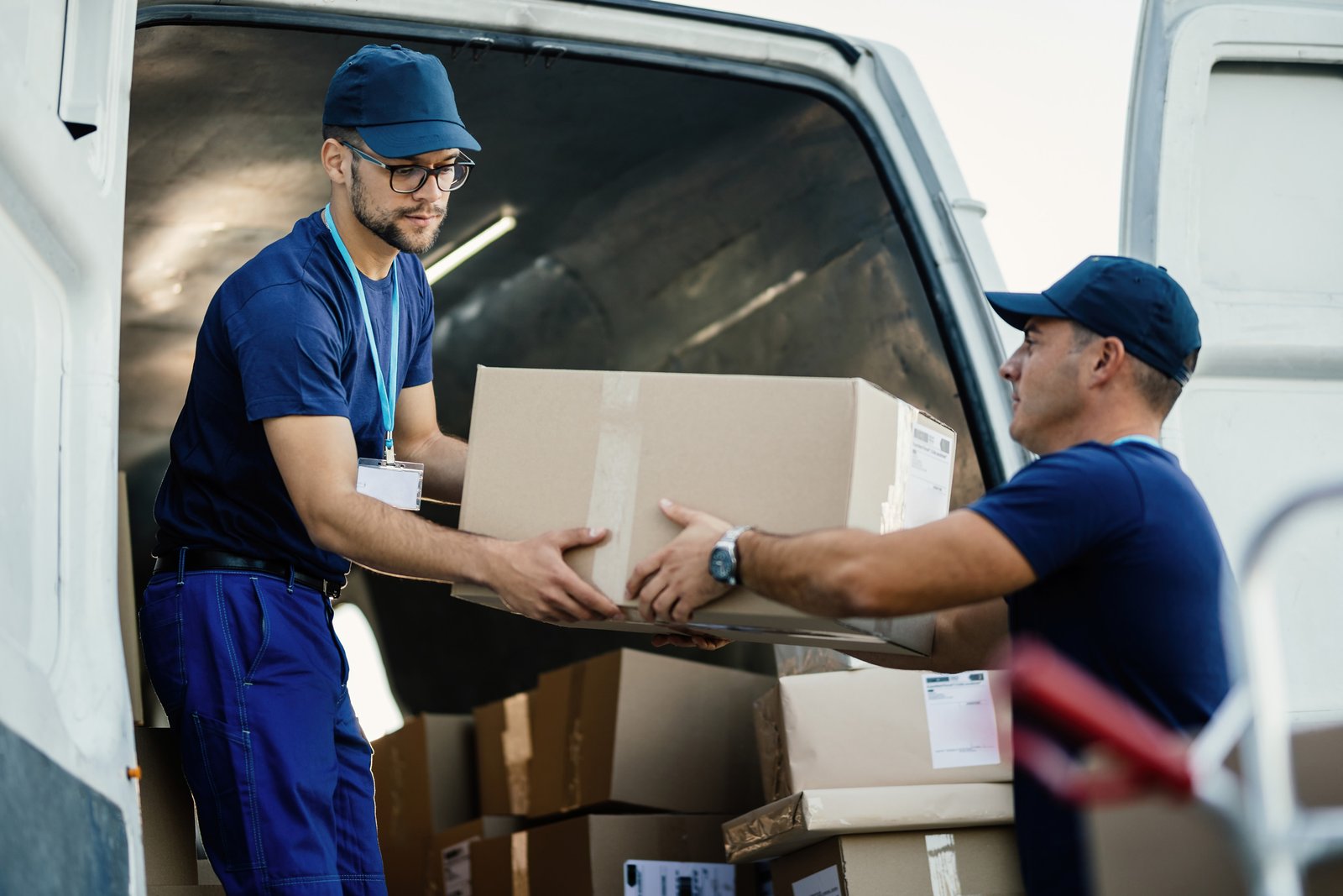Delivery partners loading a parcel into a van